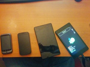 Nexus One, Galaxy Nexus, Nexus 7 2013 32GB, Nexus 5 (reflected), and finally the Nexus 7 2013 16gb destined for my car's dash.